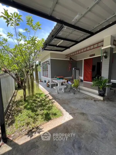 Charming outdoor patio with garden and seating area in a modern home exterior.