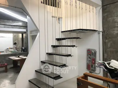 Modern industrial loft with unique suspended staircase and open layout