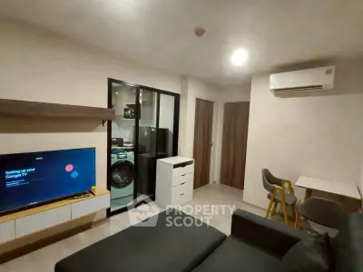 Modern living room with sleek furniture and integrated kitchen appliances