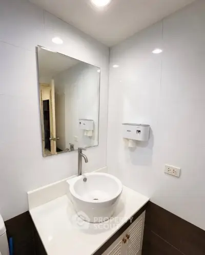 Modern bathroom with sleek sink and mirror, ideal for contemporary living spaces.