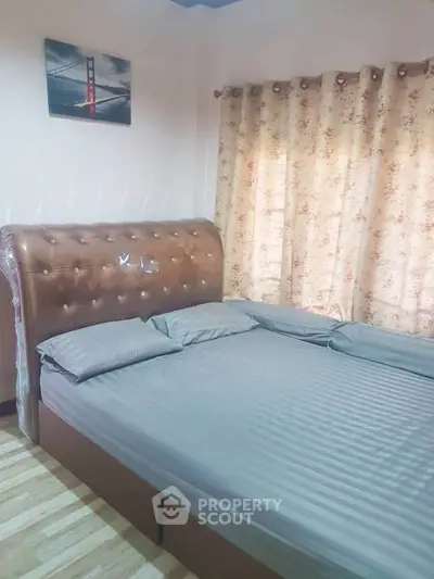 Cozy bedroom with elegant bed and floral curtains, perfect for relaxation.