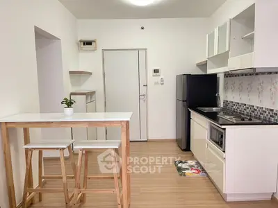 Modern kitchen with sleek design, featuring compact layout and stylish appliances.