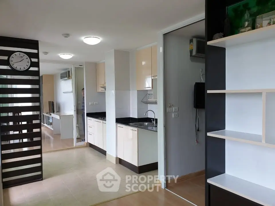 Modern open-plan apartment with sleek kitchen and spacious living area