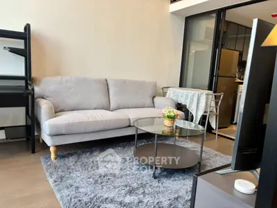 Modern living room with cozy sofa and stylish decor in open-plan apartment