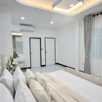 Elegant bedroom with modern lighting and cozy decor, featuring a plush bed and stylish curtains.