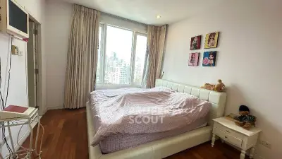 Spacious bedroom with city view, featuring a cozy bed and elegant decor, perfect for relaxation.