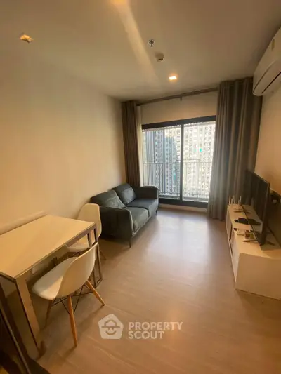 Cozy living room with modern furnishings and city view balcony access.