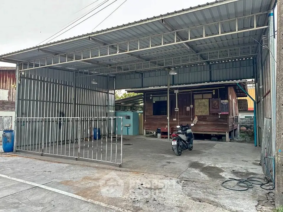 Spacious covered parking area with metal roofing and rustic wooden structure.