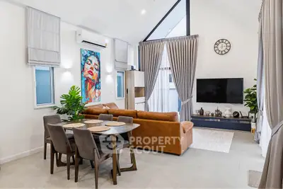 Modern living room with high ceilings, stylish decor, and natural light