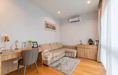 Modern living room with cozy sofa, desk, and air conditioning in bright apartment.