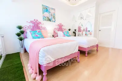 Charming twin bedroom with pink decor and stylish furnishings, perfect for a cozy and vibrant living space.