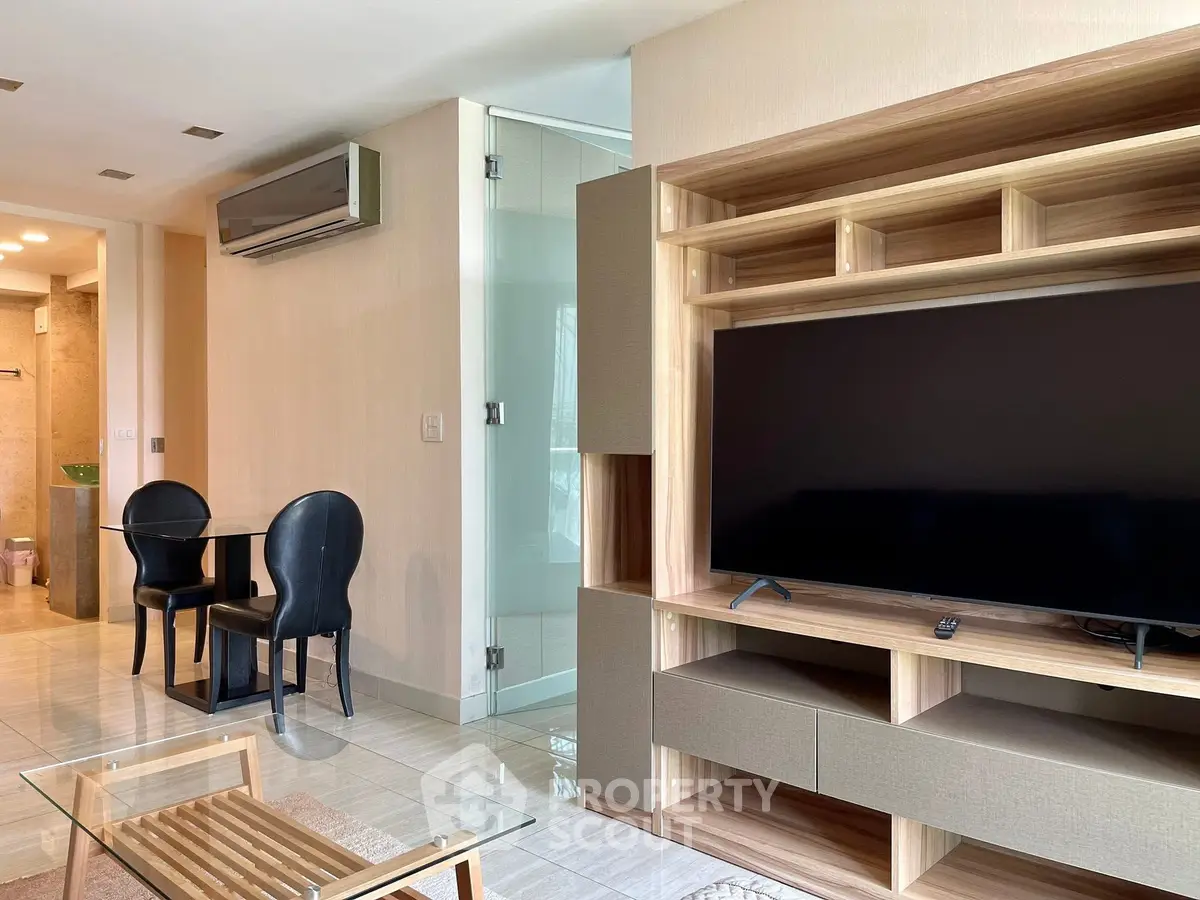 Modern living room with sleek TV unit and glass dining table