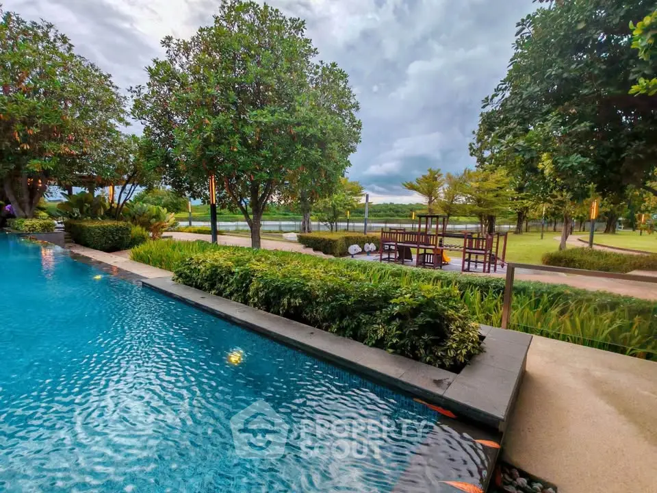 Luxurious outdoor pool with lush greenery and serene landscape view.
