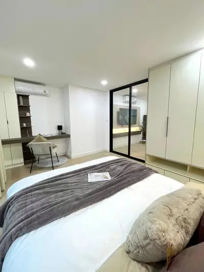 Modern bedroom with built-in wardrobe and cozy workspace