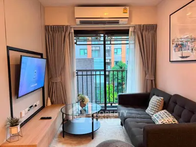 Modern living room with balcony view, featuring sleek furniture and air conditioning, perfect for urban living.