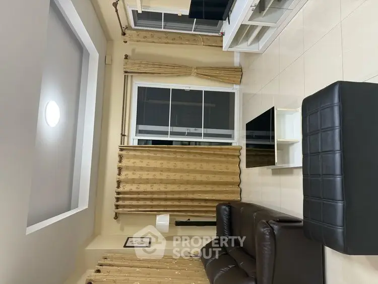 Spacious living room with modern furniture and large windows for natural light.