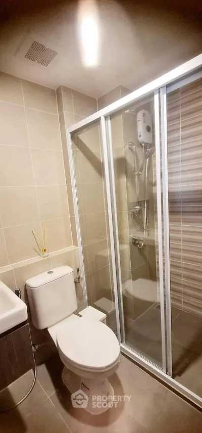Modern bathroom with glass shower enclosure and sleek fixtures