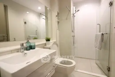 Modern bathroom with sleek fixtures and glass shower enclosure