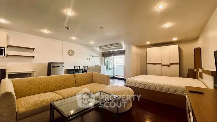 Spacious open-plan living room with modern furnishings and natural light