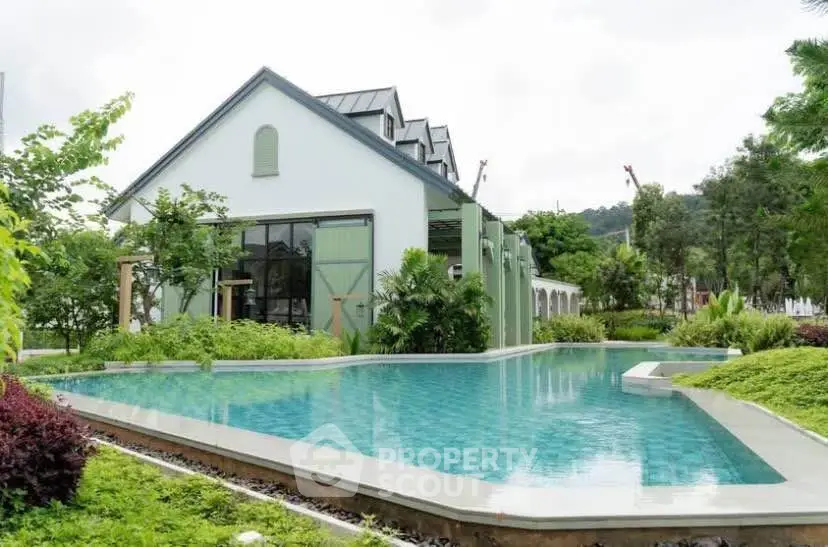 Stunning modern house with a luxurious pool and lush greenery, perfect for serene living.