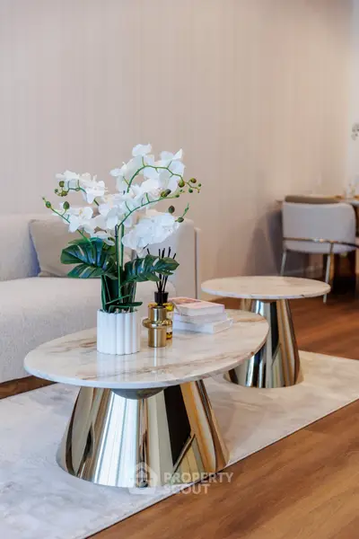 Elegant living room with modern decor and stylish furniture, featuring a chic coffee table and plush seating.
