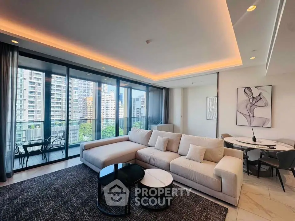 Luxurious living room with modern decor and stunning city view from large windows.