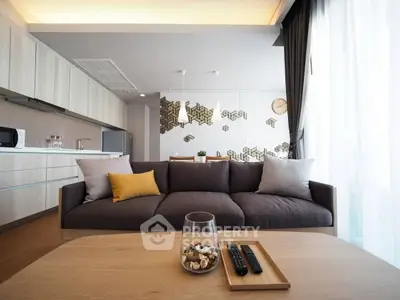 Modern living room with stylish sofa and open kitchen layout, perfect for contemporary urban living.
