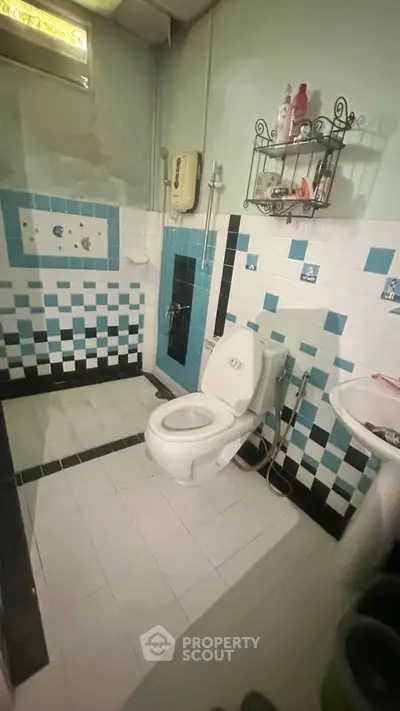 Charming bathroom with unique tile design and modern fixtures, perfect for a cozy home.