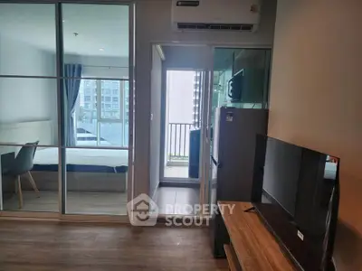 Modern apartment interior with bedroom, balcony, and living area featuring sleek furniture and appliances.