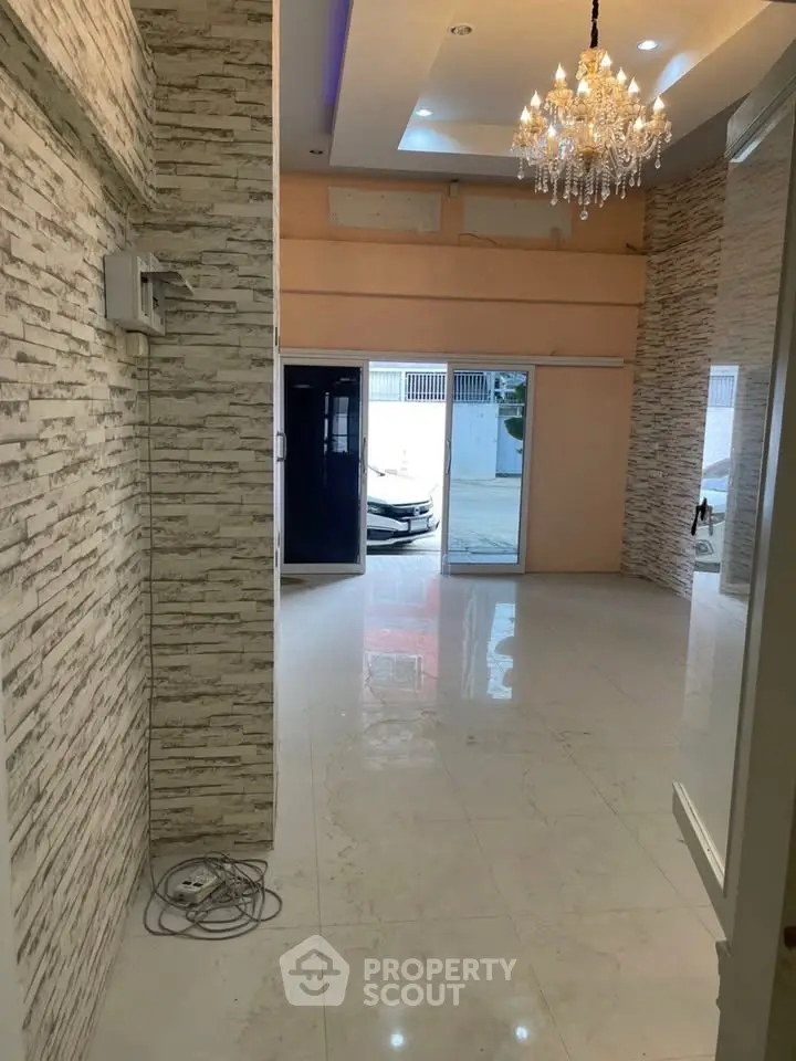 Spacious modern interior with elegant chandelier and marble flooring