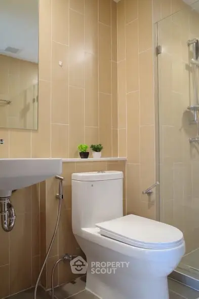 Modern bathroom with sleek fixtures and glass shower enclosure