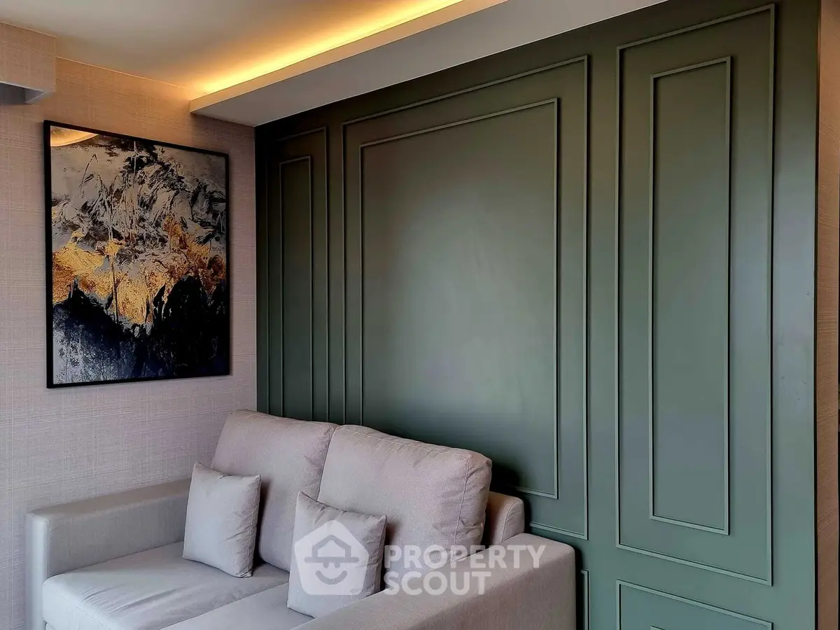 Stylish living room with modern art and elegant green accent wall