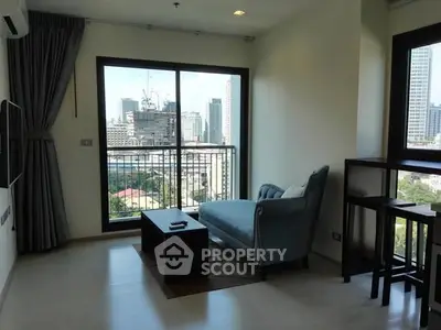 Modern living room with city view and stylish furniture in high-rise apartment.