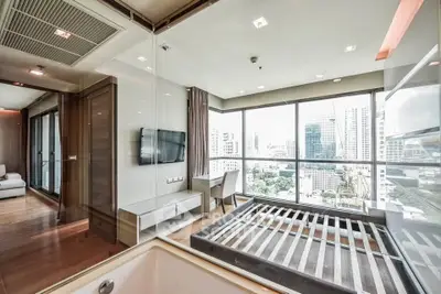 Luxurious modern bedroom with panoramic city view and sleek interior design