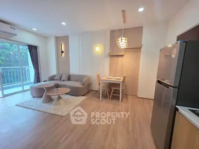 Modern living room with open layout, stylish furniture, and balcony view in a contemporary apartment.