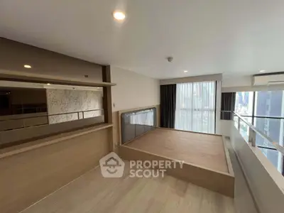 Modern bedroom with elevated platform and city view, featuring sleek design and ample natural light.