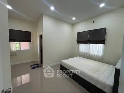 Spacious bedroom with modern design and ample natural light