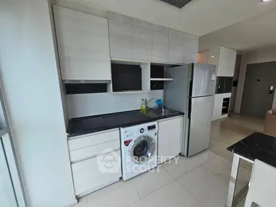 Modern kitchen with sleek cabinetry and built-in appliances in a stylish apartment.
