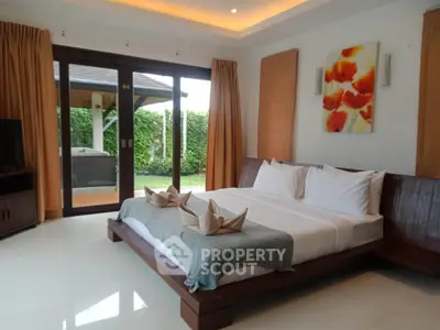 Luxurious bedroom with garden view and modern decor in a serene setting