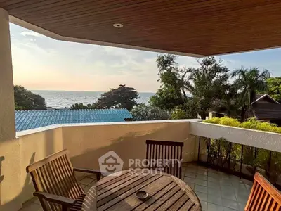 Stunning balcony with ocean view and cozy seating area, perfect for relaxation.