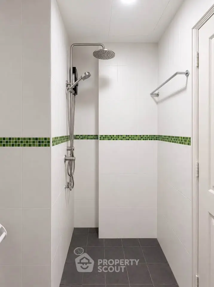 Modern bathroom with sleek shower and stylish green tile accents