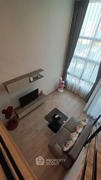 Modern living room with high ceiling and large window view