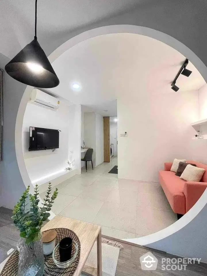 Modern living room with stylish decor and circular wall opening