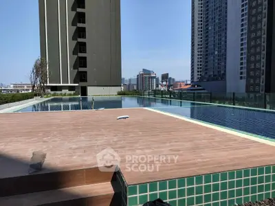 Luxurious rooftop pool with stunning city views in modern high-rise building.