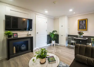 Stylish living room with modern decor, wall-mounted TV, and cozy dining area in a contemporary apartment.