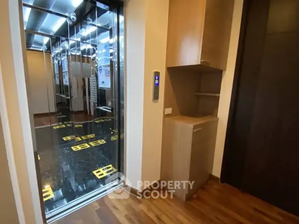 Modern building elevator with sleek design and wooden flooring