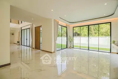 Spacious modern living room with large windows and garden view