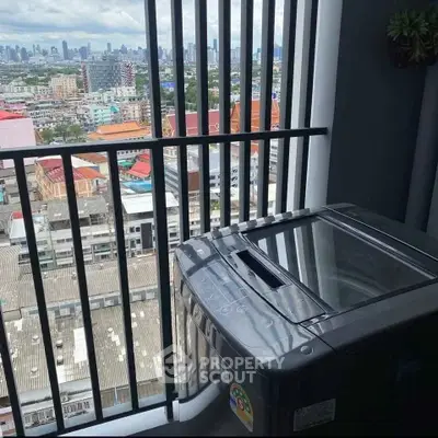 High-rise apartment with washing machine and stunning city view from balcony.