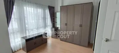 Spacious bedroom with modern wardrobe and ample natural light