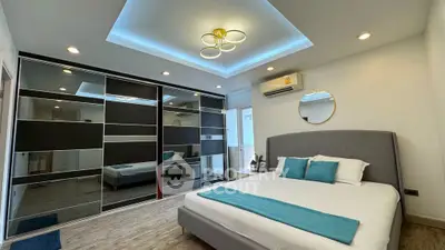 Modern bedroom with stylish ceiling lights and mirrored wardrobe